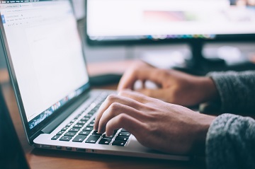 Person typing at computer